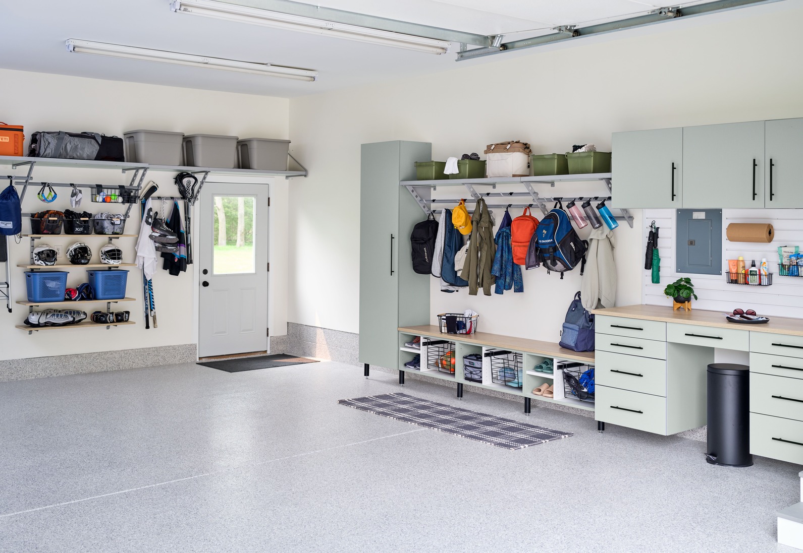 Organized garage with custom cabinets, slatwall storage, and workbench in a Georgetown, Delaware home