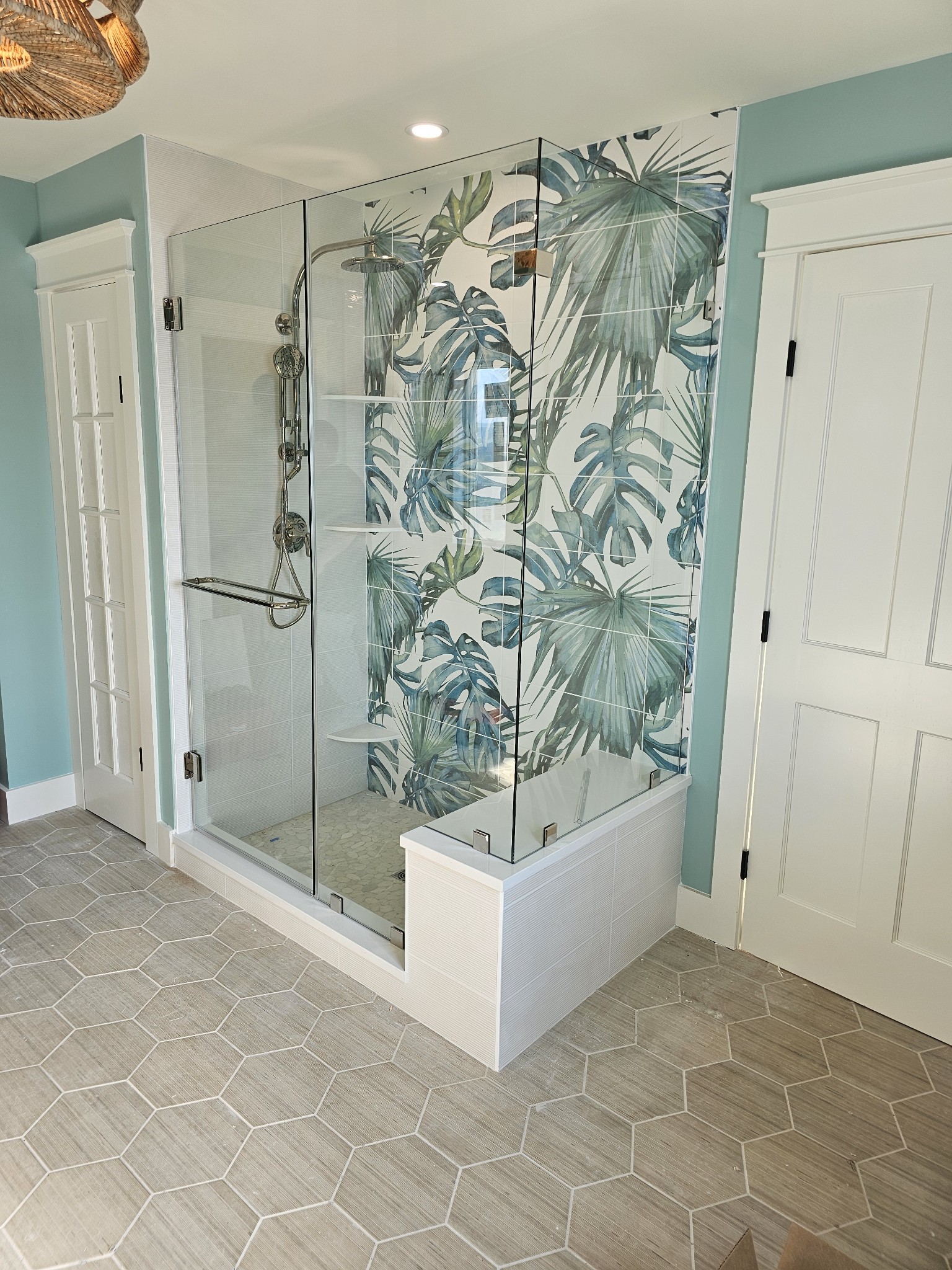 Frameless glass shower enclosure with chrome hardware in a Delaware bathroom