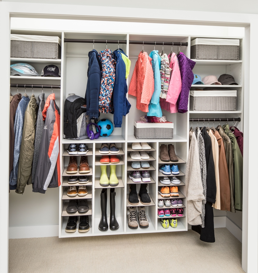 White reach-in closet with double-hang rods and shelving in a Dover, Delaware bedroom