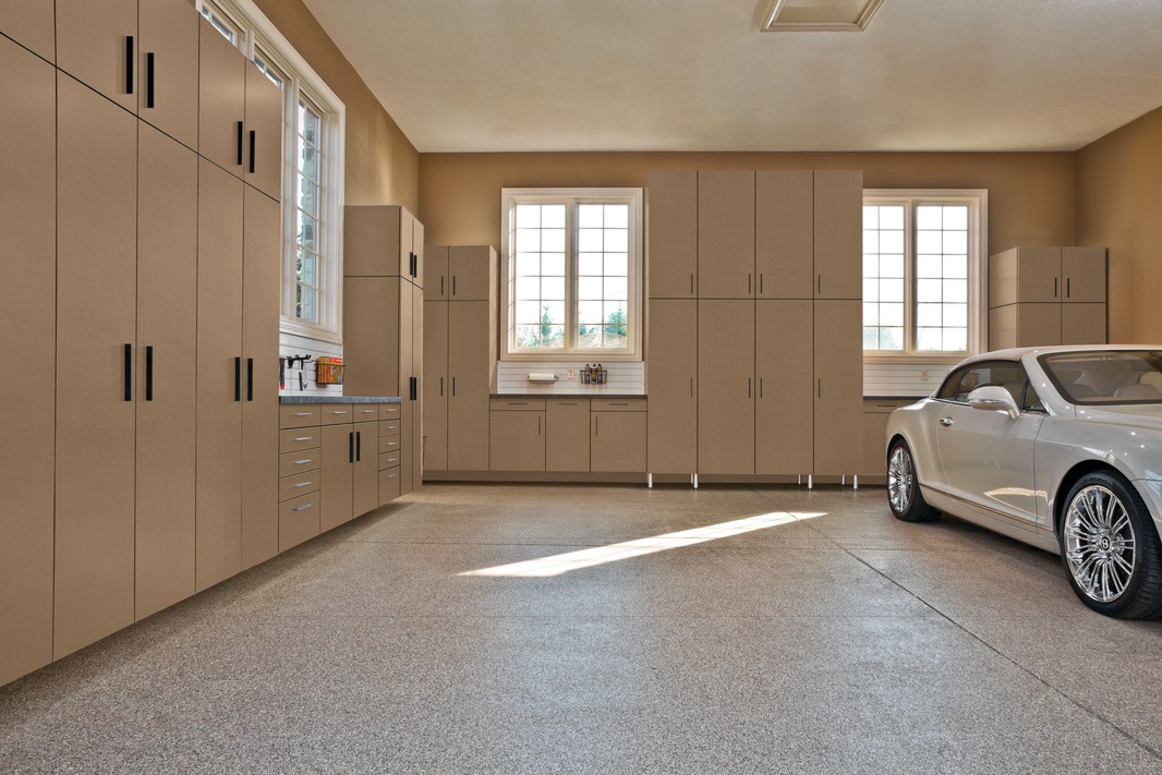Garage lined with full-height custom cabinets and a flake-coated floor by Atlantic Source in Delaware
