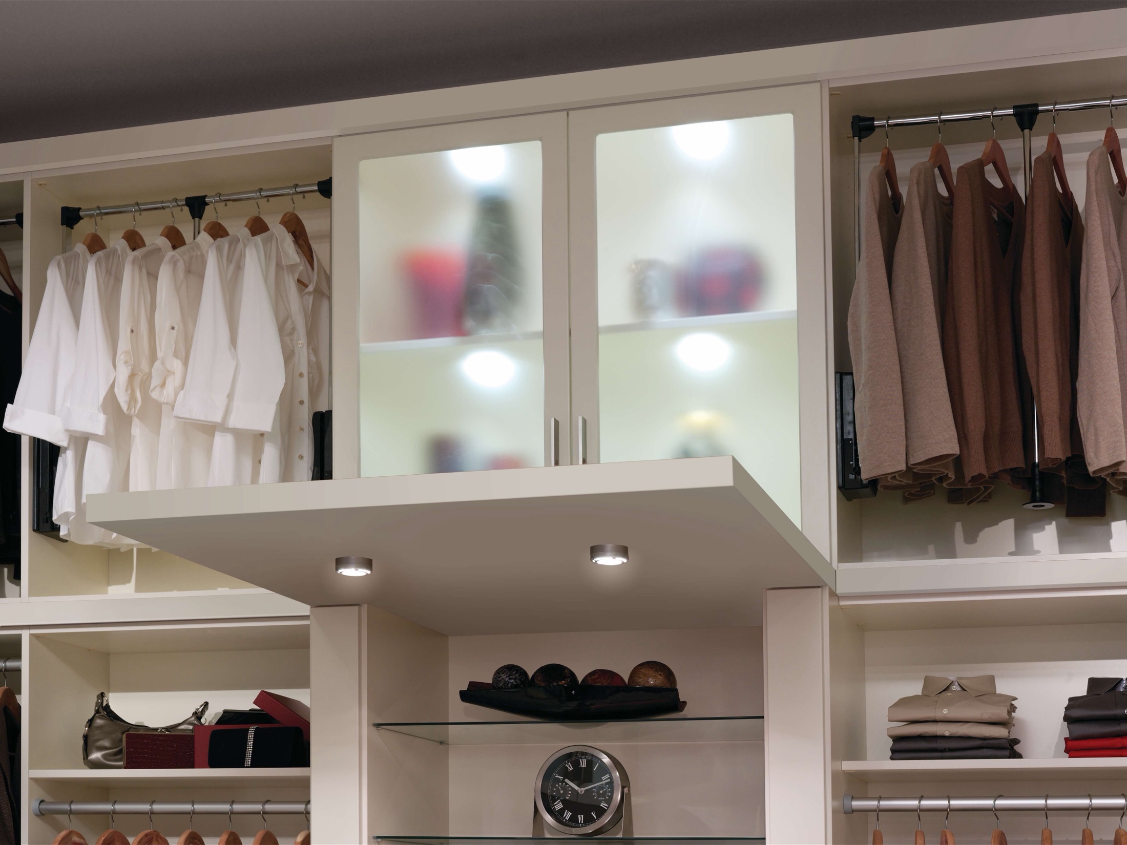 Custom walk-in closet with wood-tone shelving and soft-close drawers in a Lewes, Delaware home