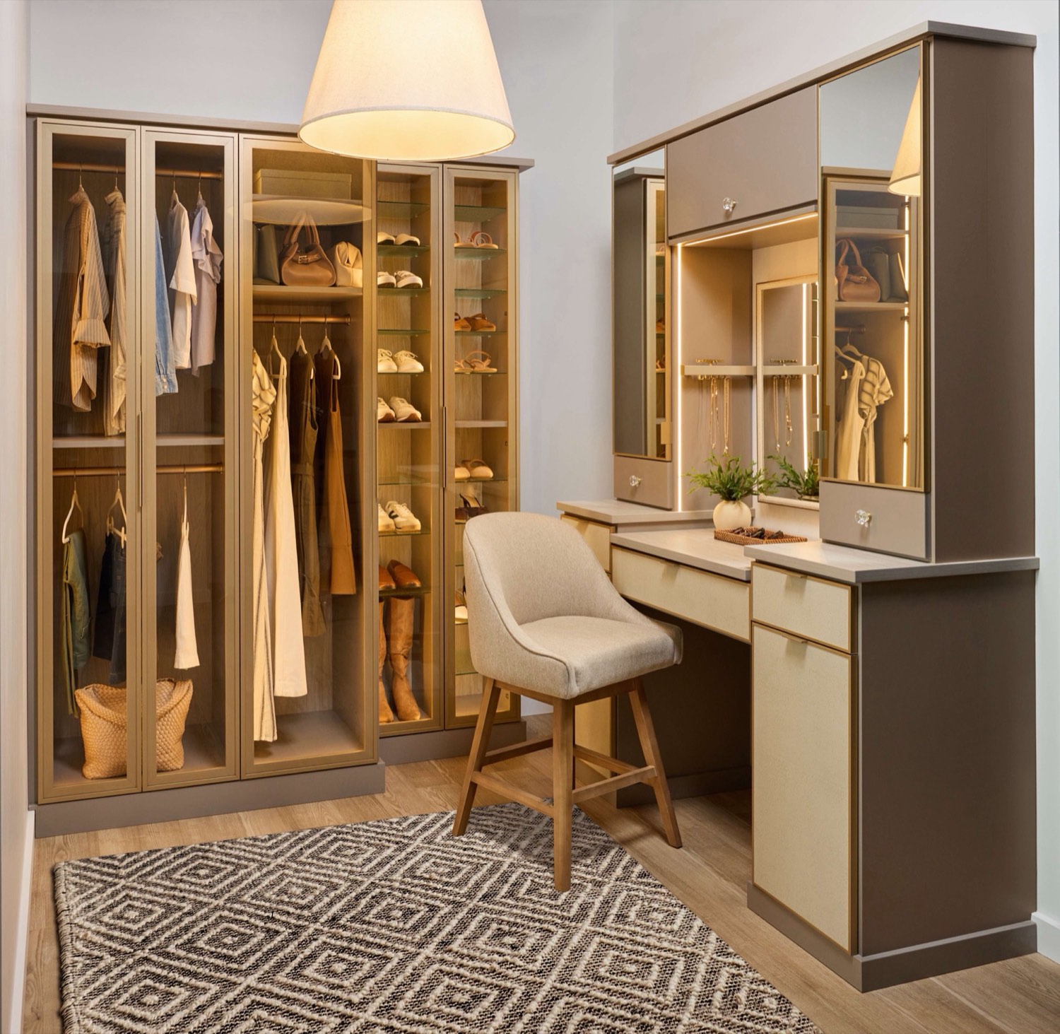 Built-in wardrobe with glass-front doors and a vanity station in a Delaware bedroom